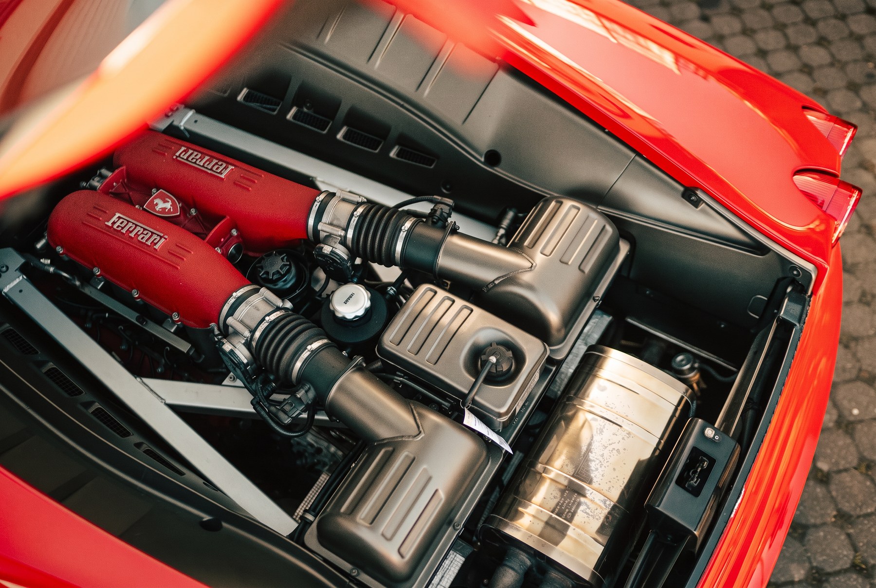 Ferrari-Motorraum in warmem Licht – technische Prüfung bei der Vor-Kauf-Inspektion